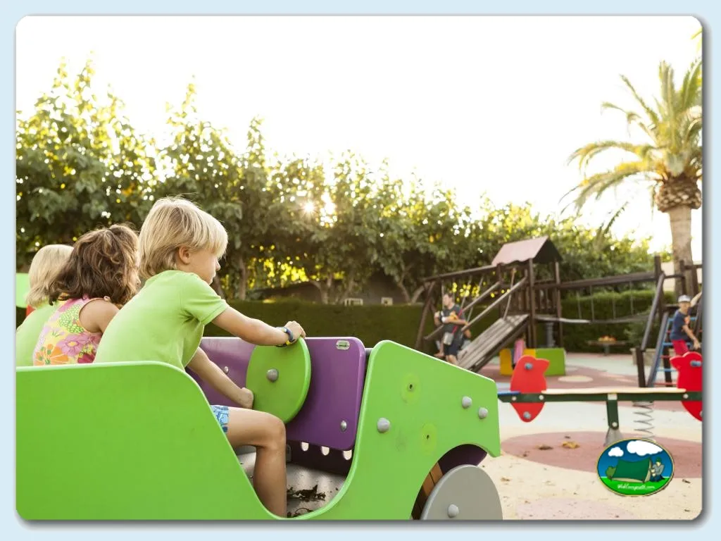 Parque infantil con juego de coche verde y niños del Camping Platja Cambrils, Cambrils (Tarragona)