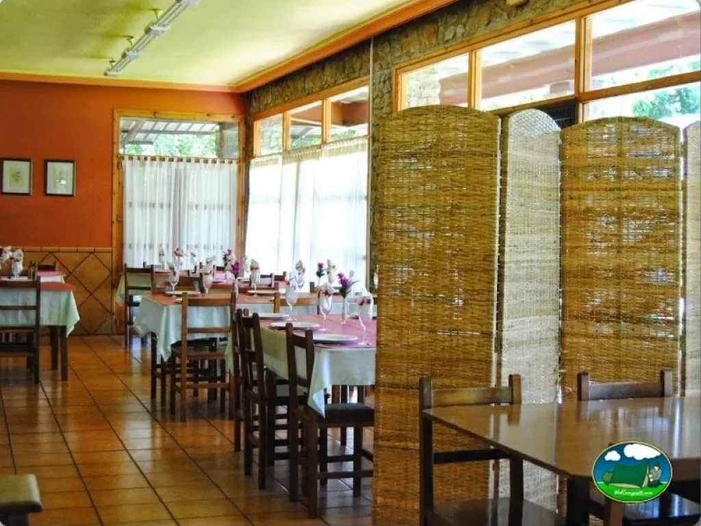 Restaurante interior con mesas y sillas del Camping Berceo, Berceo (La Rioja)
