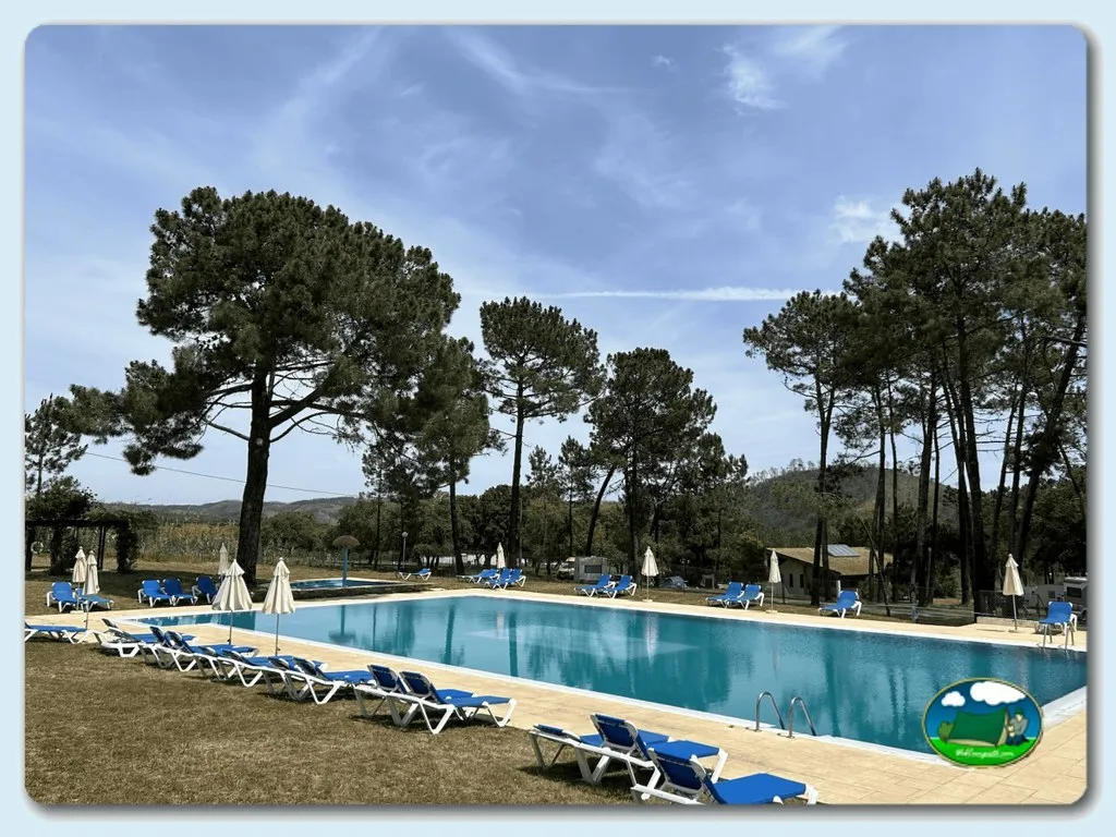 Piscina con vistas a la montaña y sombrillas del Camping San Miguel, Odemira (Beja)