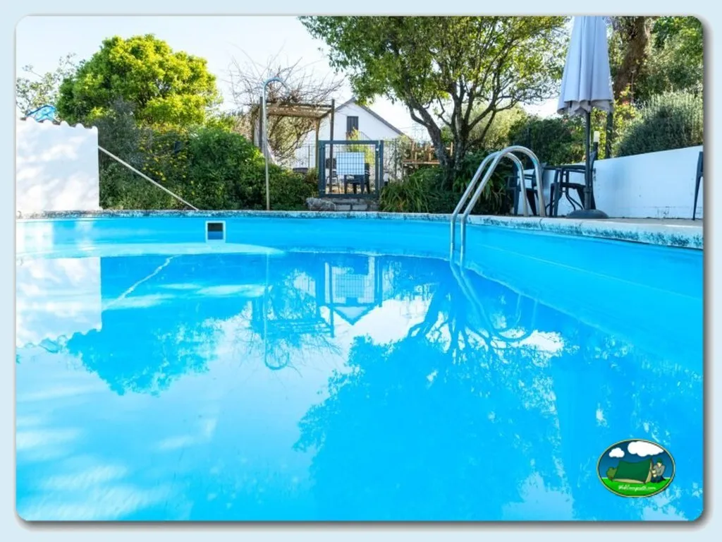 Piscina con tobogán y bungalow del Camping Quinta de Cerejeira, Ferreira do Zêzere (Santarém)