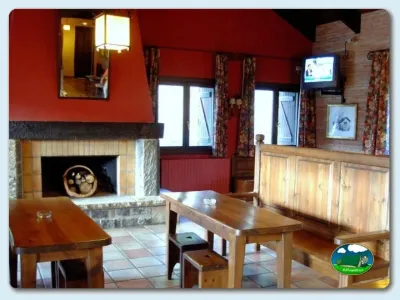 Restaurante con chimenea y mobiliario de madera del Camping Gavín, Gavín (Huesca)