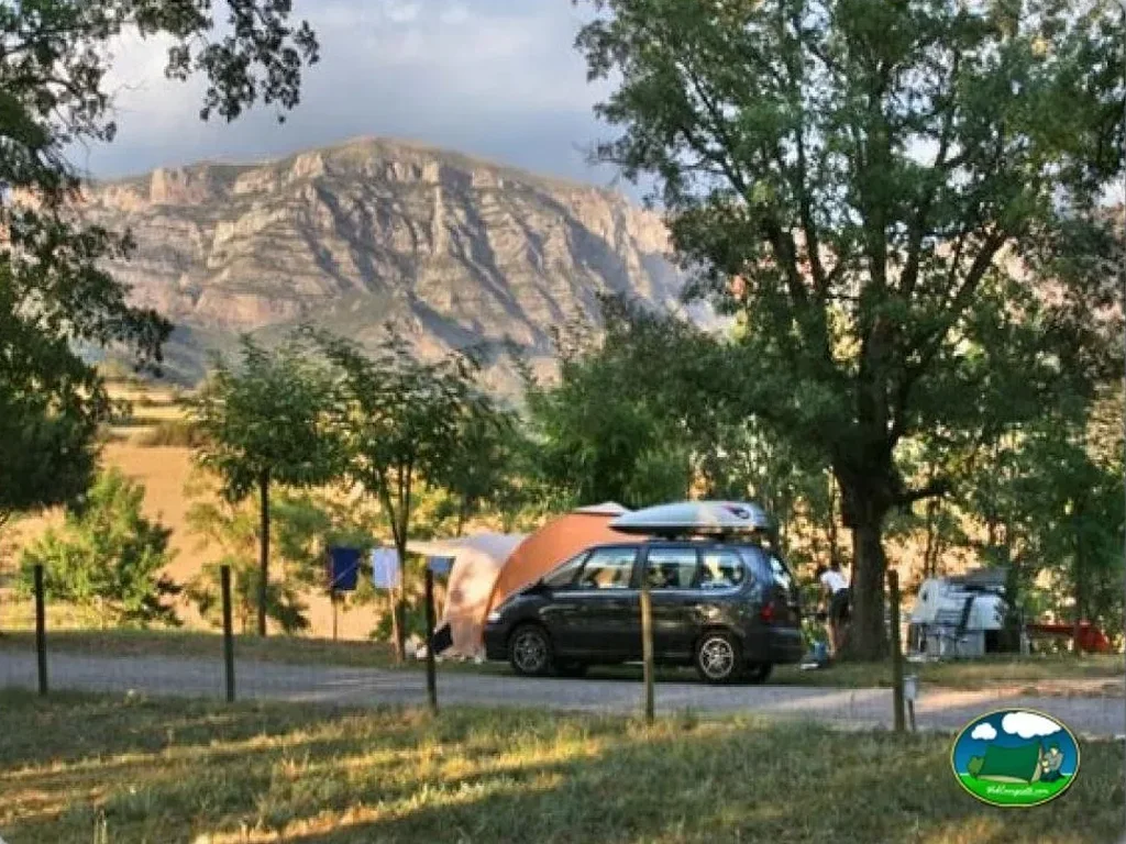 Parcela con tienda de acampada y vistas a la montaña del Camping Isabena, La Puebla de Roda (Huesca)