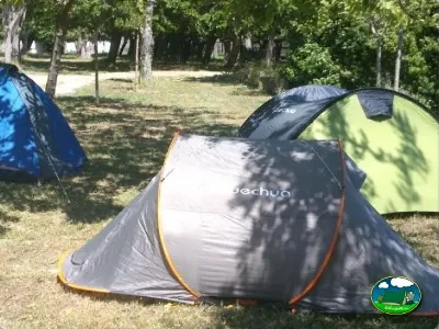 Parcela con tiendas de acampada bajo árboles del Camping Lloret Blau, Lloret de Mar (Girona)