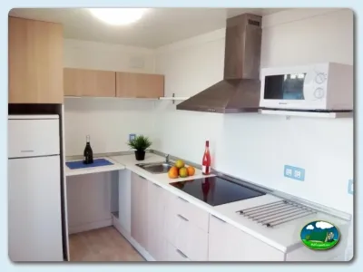 Cocina equipada con encimera, horno y nevera del Camping Eurocamping, Sant Antoni de Calonge (Girona)