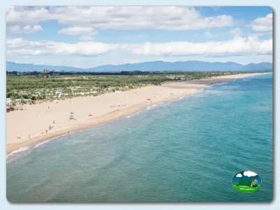 Playa junto al mar con vistas a la montaña del Camping Las Dunas, Sant Pere Pescador (Girona)