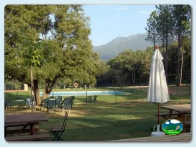 Piscina con vistas a la montaña y zona de descanso del Camping Maçanet de Cabrenys, Alt Empordá (Girona)
