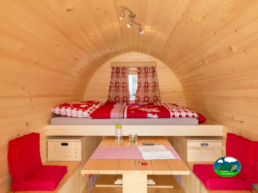 Interior del Love Iglu con cama doble y mesa de Camping Lazy Rancho, Unterseen