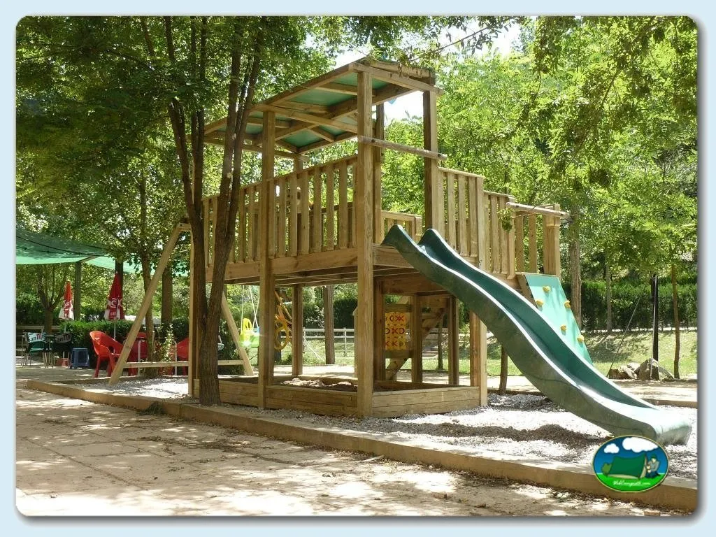 Parque infantil con tobogán y estructura de madera del Camping Besalú, Besalú (Girona)