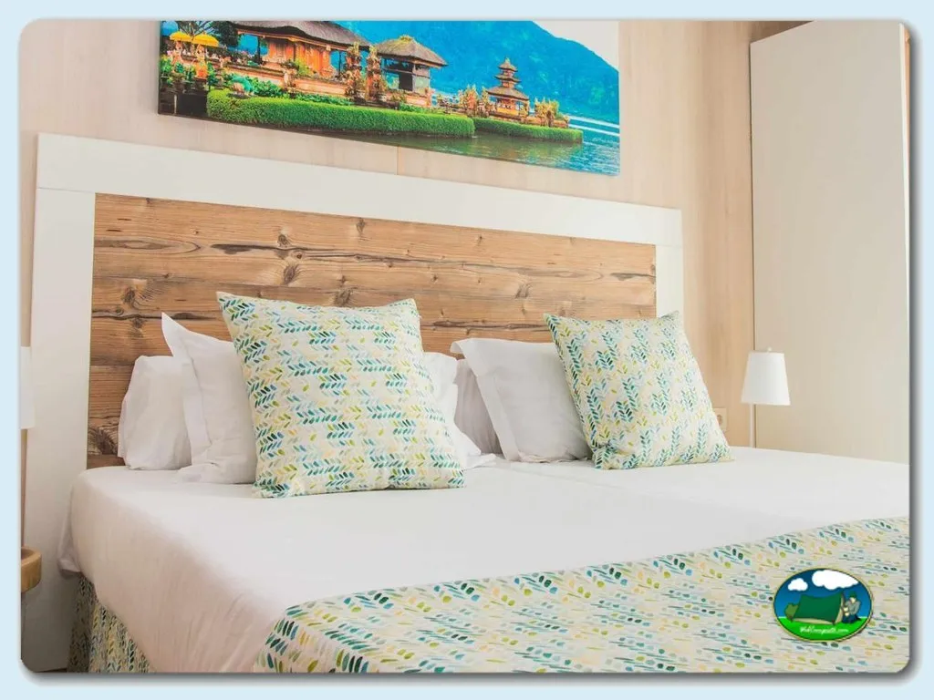 Habitación con cama doble y cabecero de madera del Camping Magic Natura, Benidorm (Alicante)