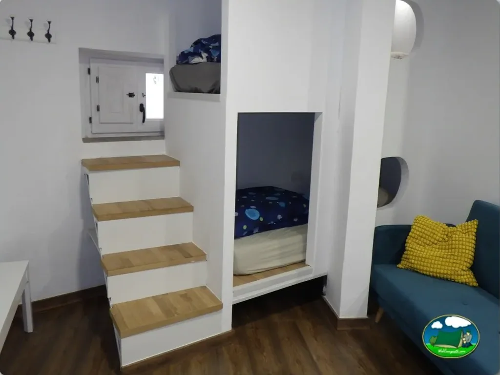 Cabaña interior con camas litera y zona de estar del Camping Kalahari Aventour, Venta del Moro (Valencia)