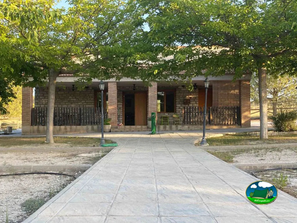 Recepción con porche de ladrillo y zona de sombra del Camping La Estepa, Valfarta (Huesca)
