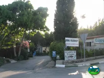 Entrada con señalética de supermercado y restaurante del Camping Parque Tropical, Estepona (Málaga)