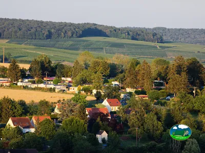 vista aérea del camping con caravanas entre árboles y viñedos en las colinas de Villiers-Saint-Denis