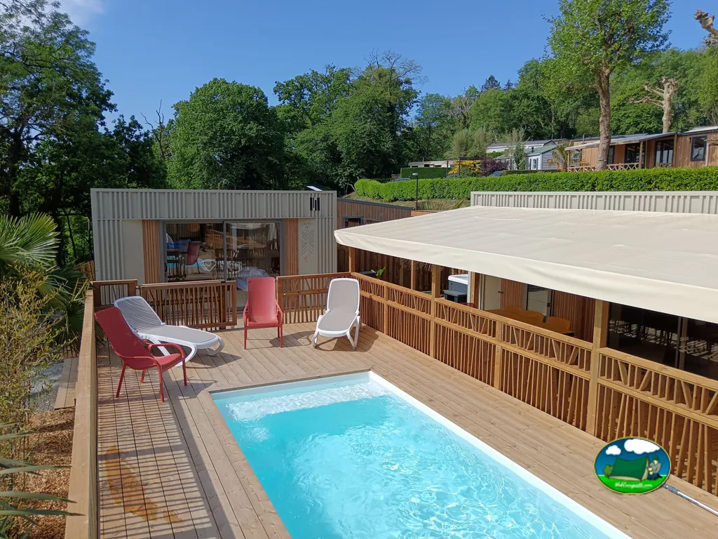 terraza elevada con piscina privada y tumbonas rojas y blancas junto a un bungalow de madera en Taden