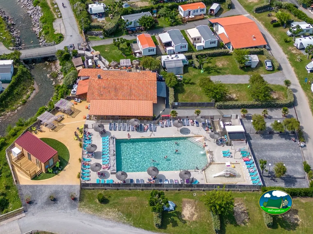 vista aérea de la piscina con tumbonas y sombrillas de paja junto al edificio principal en Saint-Jean-de-Luz