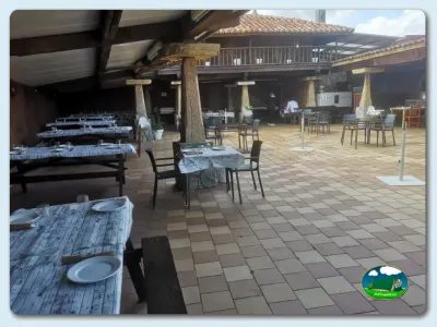 Restaurante con mesas y zona de comedor cubierta del Camping Las Gaviotas, Santa María del Mar (Asturias)