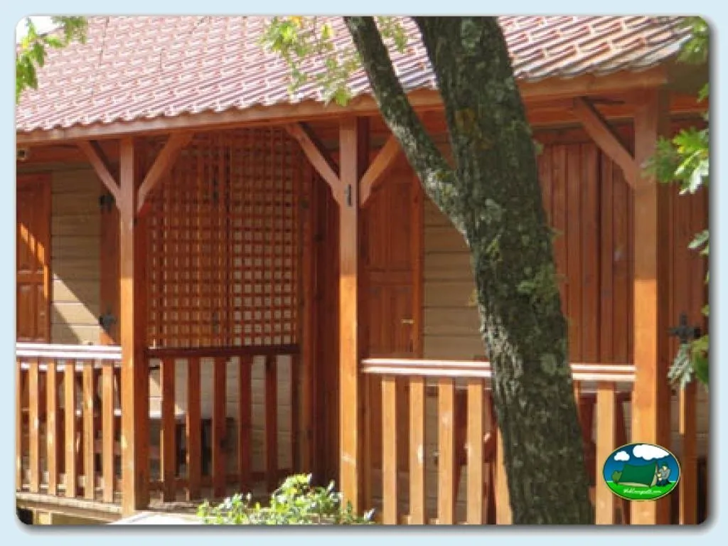 Bungalow de madera con porche y techo de tejas del Camping Riaza, Riaza (Segovia)