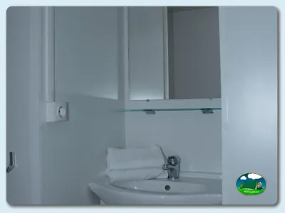 Aseos con lavabo y espejo del Camping Somo Parque, Ribamontán al Mar (Cantabria)