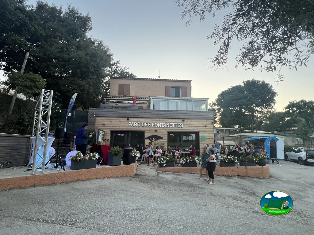 recepción del camping Parc des Fontanettes al atardecer con público en un evento en La Seyne-sur-Mer
