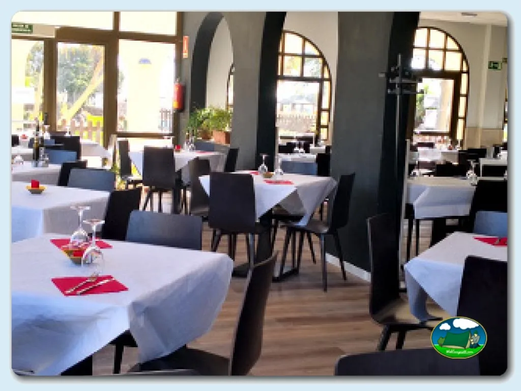 Restaurante con mesas blancas y sillas negras del Camping Los Escullos, Almería (Almería)