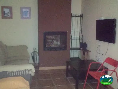 Interior de bungalow con cama y televisión del Camping Las Nogueras de Nerpio, Nerpio (Albacete)