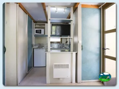 Mobil-home interior con cocina y televisión del Camping Mariola, Bocairent (Valencia)